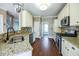 Spacious kitchen with stainless steel appliances, granite countertops, white cabinets, and wood floors at 109 Walnut Creek Rd, Charleston, SC 29414