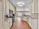 Bright kitchen featuring stainless appliances, ample white cabinetry, and complementary countertops with wood floors at 109 Walnut Creek Rd, Charleston, SC 29414