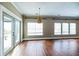Open living room features hardwood floors, large windows, and a sliding glass door at 109 Walnut Creek Rd, Charleston, SC 29414