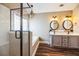 Modern bathroom featuring a glass shower, soaking tub, dual sinks, and wood look floor at 109 Walnut Creek Rd, Charleston, SC 29414