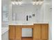 Well-lit bathroom with double sinks, vanity, granite counters and large mirror at 1106 Barfield St, Charleston, SC 29492