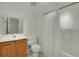 Bright bathroom featuring a shower with white curtain, wood cabinets, and a white vanity at 1106 Barfield St, Charleston, SC 29492