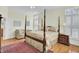 Primary bedroom with a four-poster bed, hardwood floors, and natural light from windows at 1106 Barfield St, Charleston, SC 29492
