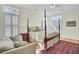 Comfortable bedroom with a four-poster bed, hardwood floors, and sitting area at 1106 Barfield St, Charleston, SC 29492