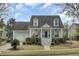 Charming two-story home with a landscaped yard, covered porch, and classic architectural details at 1106 Barfield St, Charleston, SC 29492