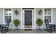 Charming entryway with rocking chairs, potted plants, and classic door hardware creates a welcoming ambiance at 1106 Barfield St, Charleston, SC 29492