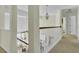Upstairs hallway overlooks the entry with neutral paint and pendant lighting at 1106 Barfield St, Charleston, SC 29492