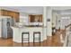 Open kitchen with stainless steel appliances, wood cabinets, breakfast bar, and hardwood floors at 1106 Barfield St, Charleston, SC 29492