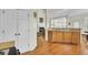Kitchen features wood cabinets, granite countertops, hardwood flooring, and a view to the living area at 1106 Barfield St, Charleston, SC 29492