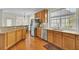 Well-lit kitchen with stainless steel appliances, wood cabinets, granite countertops, and hardwood floors at 1106 Barfield St, Charleston, SC 29492