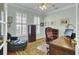 Home office features wood floors, many windows, desk, and leather furniture at 1106 Barfield St, Charleston, SC 29492