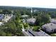 Aerial view showcasing a condo and the closest pool surrounded by lush trees and landscaping at 1204 Basildon Rd, Mount Pleasant, SC 29466