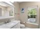 Bright bathroom featuring white vanity, mirror and a window with a view to the outdoors at 1204 Basildon Rd, Mount Pleasant, SC 29466