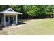 A picturesque gazebo nestled on a large lawn with lush greenery in the background at 1204 Basildon Rd, Mount Pleasant, SC 29466