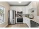 Well-equipped kitchen with stainless steel appliances, ample white cabinetry, and modern countertops at 1204 Basildon Rd, Mount Pleasant, SC 29466