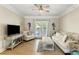 Inviting living room with a ceiling fan, a comfortable sofa, and French doors to the balcony at 1204 Basildon Rd, Mount Pleasant, SC 29466