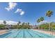 Resort-style community pool with lounge chairs and poolside cabanas under a bright blue sky with palm trees at 1204 Basildon Rd, Mount Pleasant, SC 29466