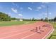 A well-maintained running track and football field under a partly cloudy sky with bright green trees in the background at 1204 Basildon Rd, Mount Pleasant, SC 29466