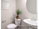 Bright half bathroom featuring a toilet, pedestal sink with chrome fixtures, and decorative elements at 1233 Homecoming Blvd # Cc2-1-34, Ravenel, SC 29470