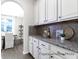 Butler's pantry with granite countertops, white cabinetry, and stylish backsplash at 1233 Homecoming Blvd # Cc2-1-34, Ravenel, SC 29470