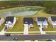 Aerial view of homes with well-manicured lawns and a serene lake backdrop at 127 Oyster Tide Ave, Summerville, SC 29485