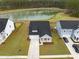 Aerial view showcasing the home's location next to a serene pond and green space at 127 Oyster Tide Ave, Summerville, SC 29485