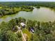 Aerial shot of the community lake and surrounding lush green landscape with a private dock at 127 Oyster Tide Ave, Summerville, SC 29485