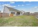 Expansive backyard with a wooden fence, swing set, and well-maintained lawn at 127 Oyster Tide Ave, Summerville, SC 29485