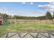 Large backyard featuring a wooden fence, swing set, and lush green grass at 127 Oyster Tide Ave, Summerville, SC 29485