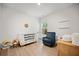 Bright Bedroom features a white crib, comfortable blue armchair, and hardwood floors at 127 Oyster Tide Ave, Summerville, SC 29485