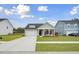 Charming single-story home with a well-manicured lawn and welcoming front porch seating at 127 Oyster Tide Ave, Summerville, SC 29485