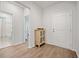 Bright hallway leading to a bathroom, featuring wood flooring and neutral walls at 127 Oyster Tide Ave, Summerville, SC 29485