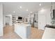 Modern open-concept kitchen features an island, stainless steel appliances, and flows seamlessly into the living area at 127 Oyster Tide Ave, Summerville, SC 29485