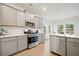 Updated kitchen boasts stainless steel appliances, granite counters, and ample cabinet space at 127 Oyster Tide Ave, Summerville, SC 29485