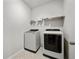 Clean laundry room equipped with a washer, dryer, and storage shelves at 127 Oyster Tide Ave, Summerville, SC 29485