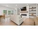 Cozy living room with a fireplace, floating shelves, and views of the outdoors at 127 Oyster Tide Ave, Summerville, SC 29485