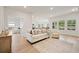 Bright living room with a neutral color palette, a comfortable sofa, and natural light at 127 Oyster Tide Ave, Summerville, SC 29485