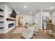 Open-concept living area featuring a modern fireplace, kitchen bar, and luxury vinyl floors at 127 Oyster Tide Ave, Summerville, SC 29485