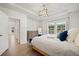The main bedroom offers natural light, stylish furnishings, and wood flooring for a comfortable and airy space at 127 Oyster Tide Ave, Summerville, SC 29485