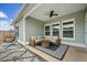 Covered patio with comfortable seating, ceiling fan, and stylish outdoor rug at 127 Oyster Tide Ave, Summerville, SC 29485