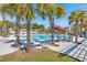 Relaxing community pool surrounded by lounge chairs, palm trees, and shaded pergolas at 127 Oyster Tide Ave, Summerville, SC 29485
