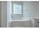 Bright bathroom features a large soaking tub with a window at 1338 Hopton Cir, Mount Pleasant, SC 29466