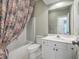 Bright bathroom features a shower-tub combo with floral shower curtain and a large mirror at 1338 Hopton Cir, Mount Pleasant, SC 29466