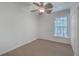 The bright bedroom has neutral carpet and trim, and is illuminated by natural light from a large window at 1338 Hopton Cir, Mount Pleasant, SC 29466