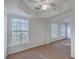 Spacious primary bedroom with tray ceilings, carpet flooring, and windows at 1338 Hopton Cir, Mount Pleasant, SC 29466