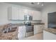 Charming kitchen features stainless steel appliances, granite countertops, and white cabinetry at 1338 Hopton Cir, Mount Pleasant, SC 29466