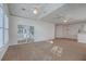 Sunlit living room with a vaulted ceiling, sliding glass doors, and neutral carpeting at 1338 Hopton Cir, Mount Pleasant, SC 29466