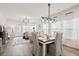 Cozy dining area open to the living room, with a modern light fixture, and abundant natural light at 136 Post Mill Dr, Summerville, SC 29485