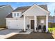 Attractive home featuring an attached garage, welcoming front porch, and tidy landscaping at 136 Post Mill Dr, Summerville, SC 29485