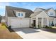 Beautiful home with a well-maintained lawn, a white garage door, and an inviting front porch at 136 Post Mill Dr, Summerville, SC 29485